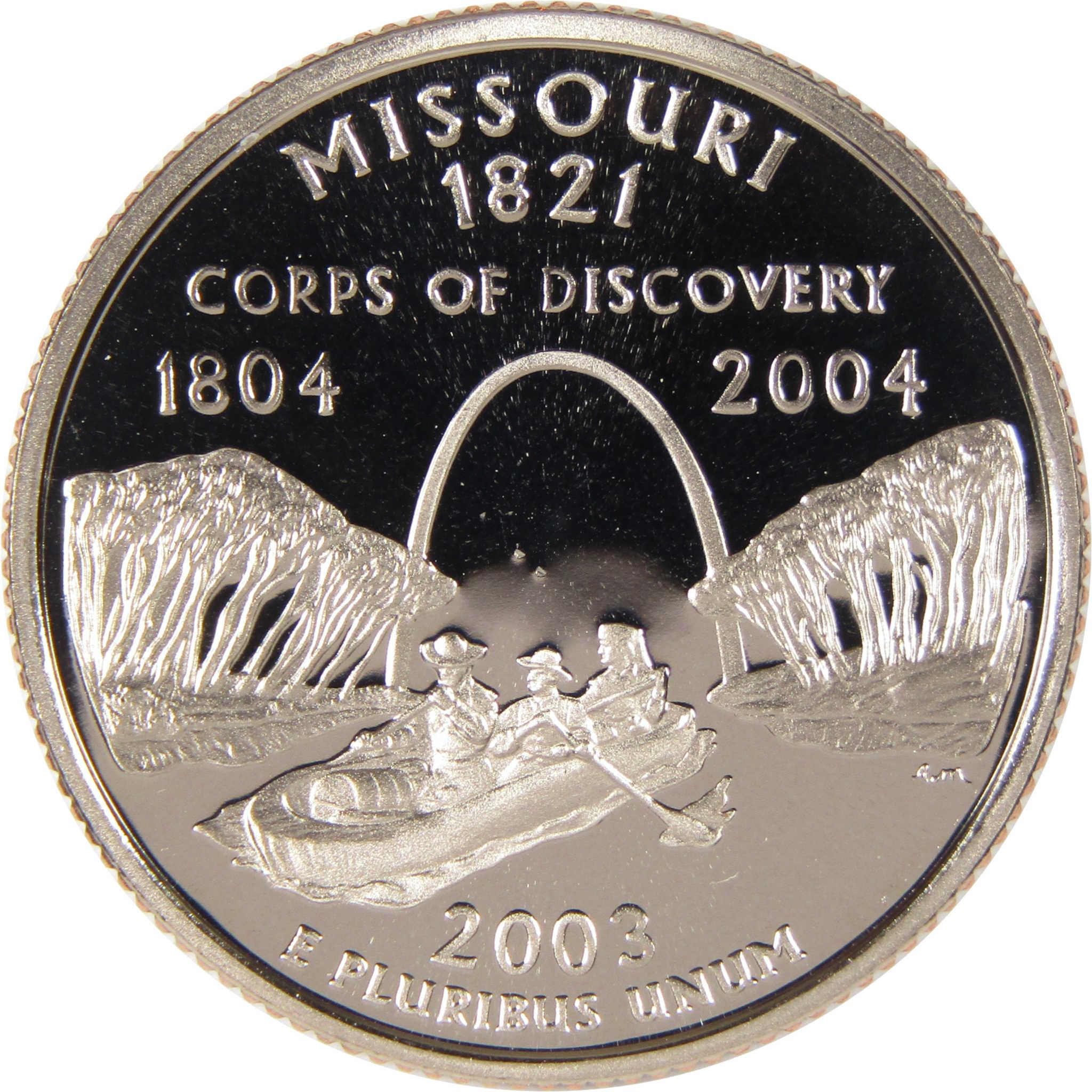 Missouri commemorative coin featuring explorers in a canoe, Gateway Arch, and trees.